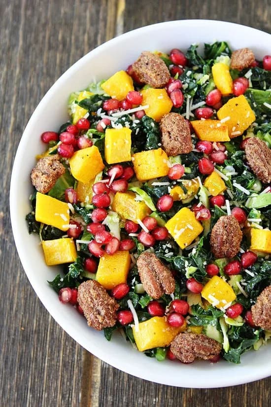 Kale and Brussels Sprouts Salad with Butternut Squash, Pomegranate, and Candied Pecans